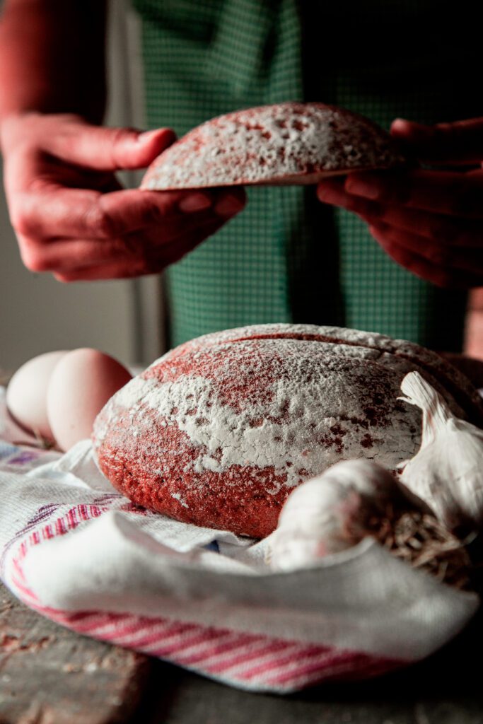 thin sliced black bread man puting slice hand egg bowl white towel with garlic side view