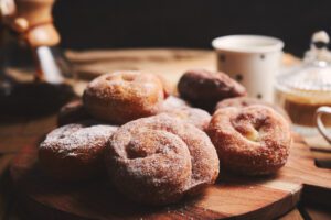 snake doughnuts with powdered sugar chemex coffee wooden table