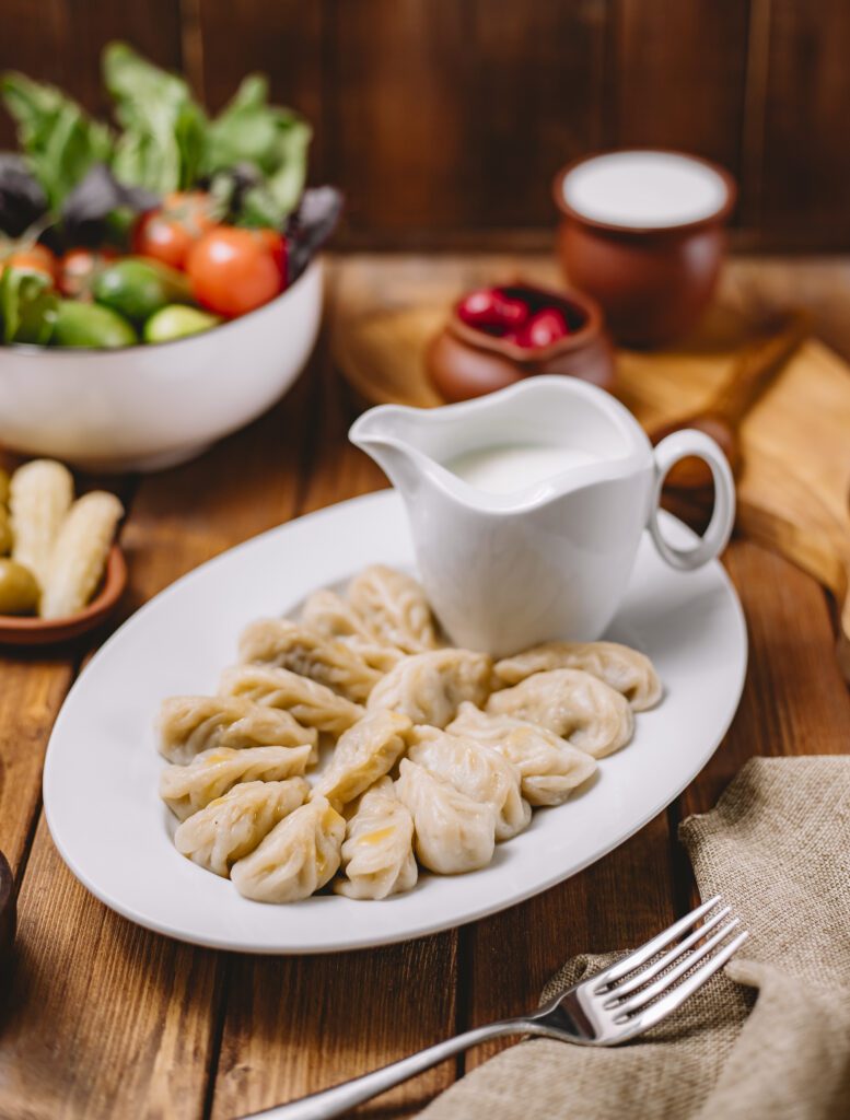 gurza dumplings platter served with yogurt
